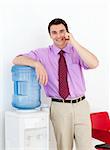 Businessman on phone by the watercooler in the office