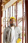 latin american construction worker looking at camera.