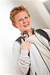 Teenage boy outside classroom with backpack and headphones
