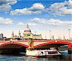 Blackfriars Bridge, St. Paul's Cathedral and cruise boat in London