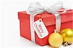 Red Christmas gift with tag and golden ornament