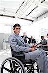 Young businessman in a wheelchair looking at the camera