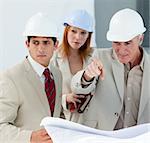 Engineers studying blueprints in a building site