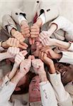 Multi-ethnic business people with thumbs up lying on the floor. Concept of success.