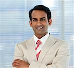 Smiling businessman with folded arms in a business building