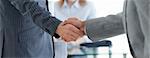 Close-up of businessmen shaking hands in an ooffice