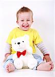 Portrait of cute toddler laughing with toy