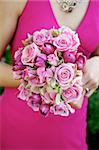Image of a bridesmaid in a pink dress holding a pink bouquet