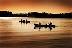 Image of silhouette of canoers on a lake