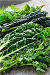 Dark green leafy fresh vegetables on cutting board