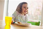 Girl Eating at Kitchen Table