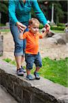 Mother and Son Walking on Stone Wall, Washington Park, Portland, Oregon, USA