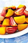 Closeup of roasted sliced red and golden beets on a plate