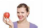 beautiful young blonde woman with a red apple