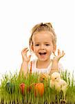 Happy little girl with easter eggs and baby chickens in the grass - isolated
