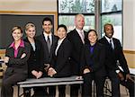 Business people in conference room smiling.  Horizontally framed shot.