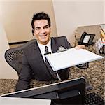 Man holding sign in sheet on clipboard.  Square framed shot.