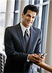 Young businessman texting.  Vertically framed shot.