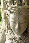 Carved stone statue of the Buddhist Goddess Kuan Yin. Vertical shot.