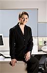 Businesswoman sitting on desk