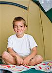 Boy sitting in tent