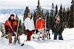 Portrait of group of skiers standing on ski slope in Colorado smiling with a valley in background