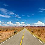 Rural State Route 261 in Utah with scenic landscape and blue sky in background. Square shot.