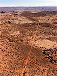 Aerial of intersecting dirt roads in a desert landscape. Vertical shot.