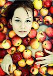 The beautiful girl floating in apples photo