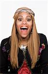 Portrait of a happy, excited young woman. She is looking at the camera, and dressed in individualistic attire. Vertical shot. Isolated on white.