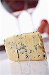 Roquefort soft blue french cheese.  A wine at background