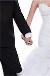 Bride and groom hands holded together over white background