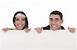 Newly married couple standing behind the board in white background