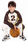 Kid stylishly sitting on the ball, isolated background