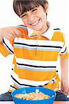 Young boy eating his breakfast on isolated white background