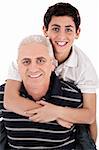 Grandfather piggybacking his grandson on isolated background