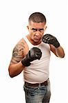 Hispanic man doing mixed martial arts wearing gloves