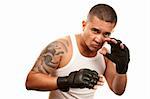Hispanic man in t-shirt wearing mixed martial arts gloves