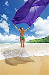 Woman with sarong on beautiful beach