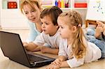 Family online - kids learning the use of computers with their mother