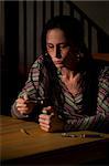 Woman cooking heroin in a bent spoon