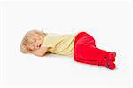 beautiful boy with long blond hair sleeping on the floor