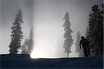 Silhouet shot of a young snowboarder hiking  a park kicker at Stevens Pass, Washington