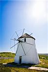 A frontal view of a windmill in action on a sunny day.