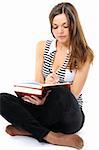 Beautiful girl doing homework on a white background