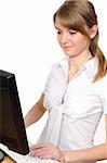 Business woman portrait smiling in front of her desktop computer. Side View