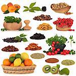 Healthy super food collection of fresh and dried fruit, nuts, herbs, spices, and pulses, very high in antioxidants and vitamins, isolated over white background.