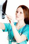 Pretty female doctor looking at xray picture