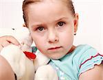 Portrait of sad little girl with teddy