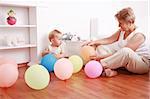 Cute little boy playing with his grandmother